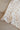 Beige leopard print blanket draped over a beige couch