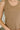 A close-up of a person wearing a ribbed scoop-neck tank top in a warm taupe-brown color.