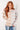 Woman wearing a striped sweater against a white background