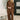 A woman models a matching brown lounge set consisting of a long-sleeve top and wide-leg pants, styled with beige slip-on shoes in a modern indoor setting.