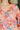 Colorful floral patterned top worn by a person