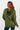 Person wearing an olive green hoodie with a white background