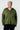 Woman wearing an olive green hoodie against a white background